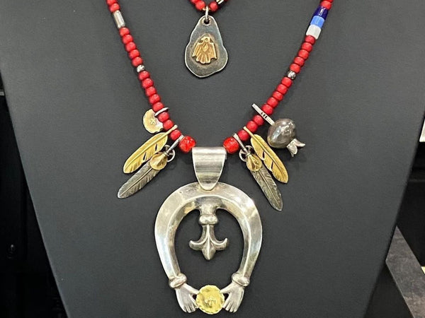 goros najone pendant setup with feathers and read beads